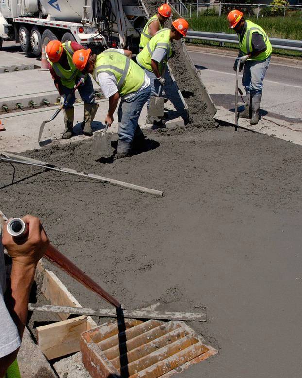 Artisan Concrete crew screeding a fresh concrete slab